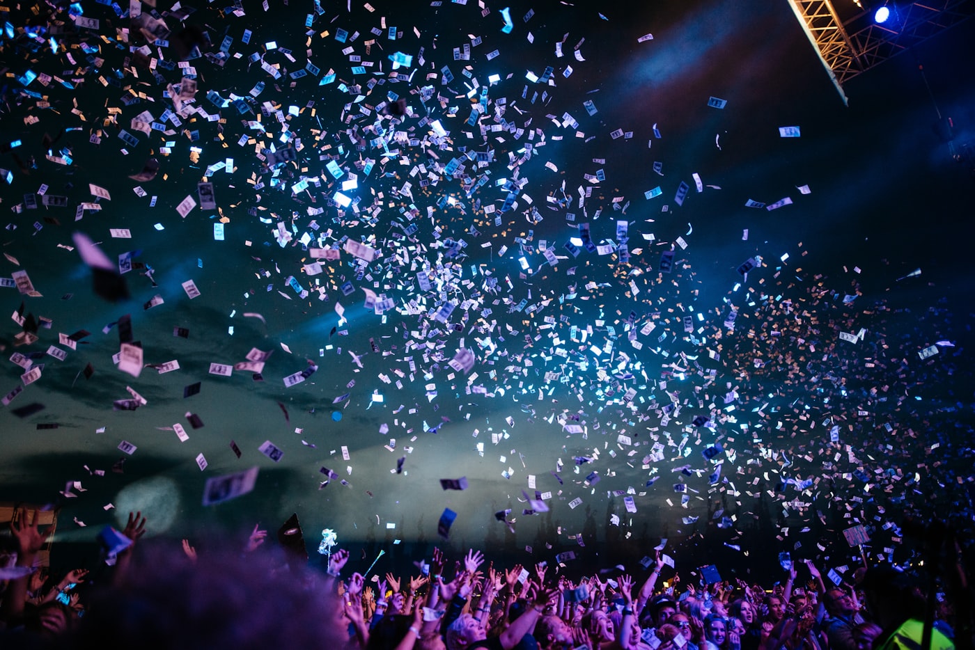 Confetti and lights over a crowd at a promotional event